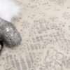Decorative silver bottles on patterned carpet