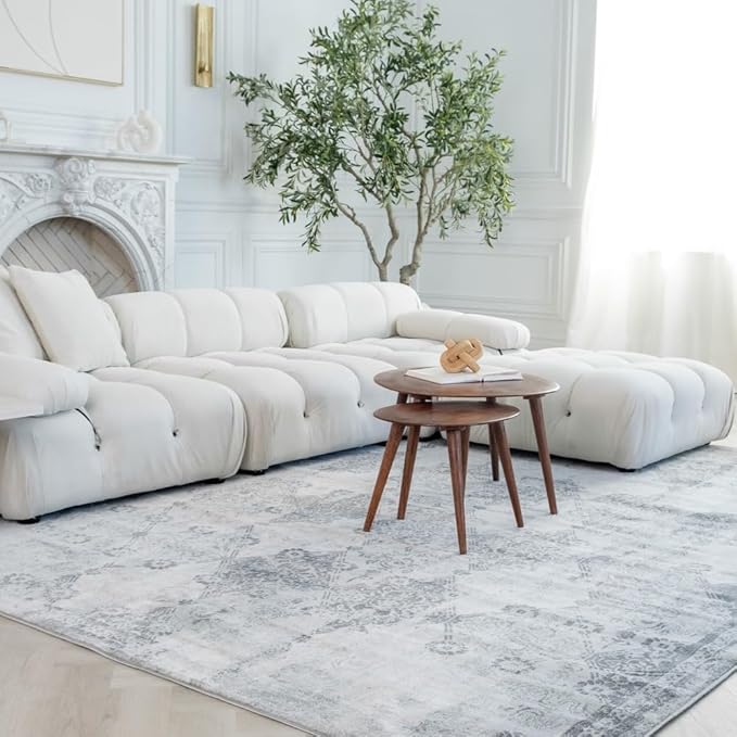 Modern living room with white sofa and tables.