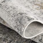 Close-up of textured gray carpet fold.