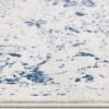 Textured blue and white patterned rug close-up.