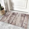Rustic doormat on gray tiled floor near door.