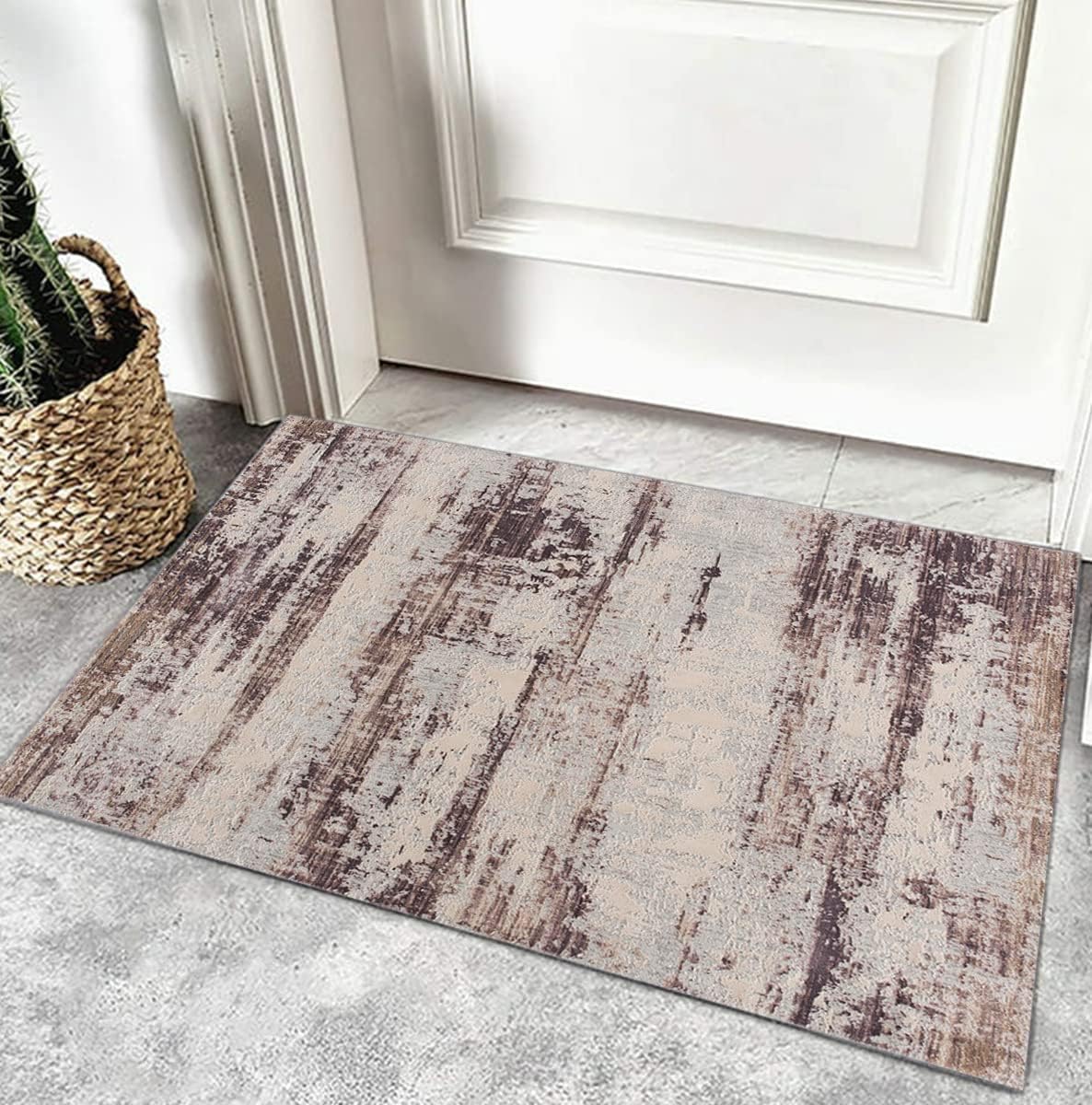 Rustic doormat on gray tiled floor near door.