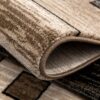 Close-up of folded beige and brown rug