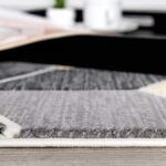Geometric gray rug on wooden floor