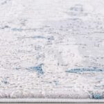 Textured area rug with blue and white pattern.