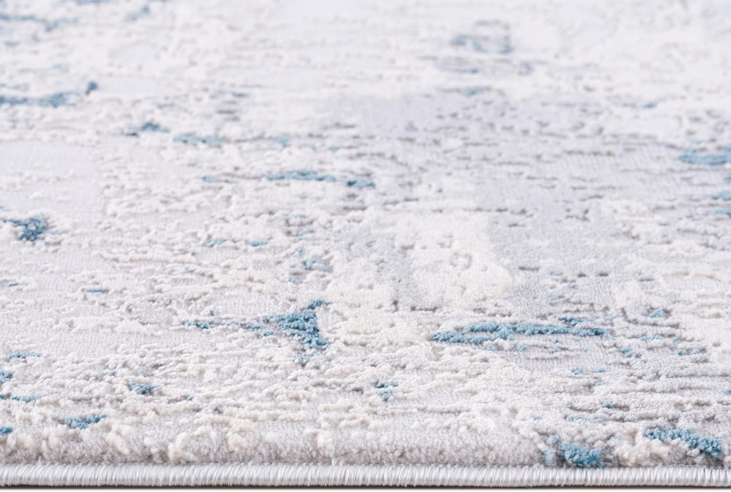 Textured area rug with blue and white pattern.