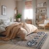 Cozy bedroom with neutral decor and sunlight.