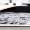 Close-up of gray patterned carpet edge.