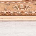 Detailed beige floral carpet on wooden floor