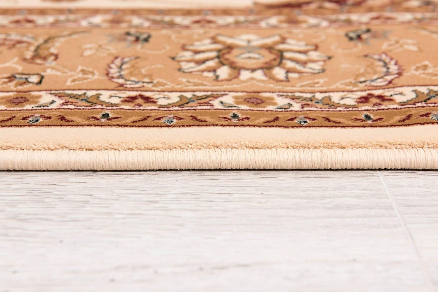 Detailed beige floral carpet on wooden floor