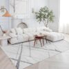 Modern living room with white sofa and coffee table.