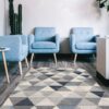 Modern waiting room with blue chairs, geometric carpet.