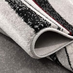 Close-up of folded striped carpet on floor.