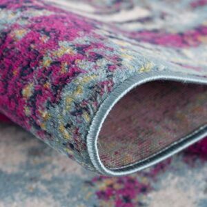 Colorful woven tapestry close-up with pink and blue hues.