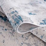 Close-up of abstract blue and gray patterned carpet.