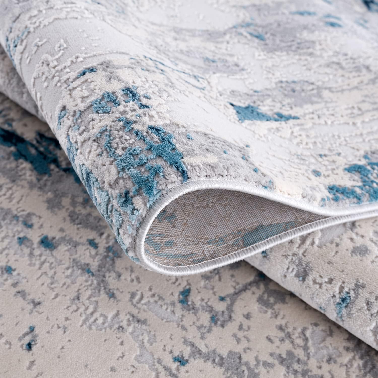 Close-up of abstract blue and gray patterned carpet.