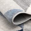 Close-up of folded gray and blue rug