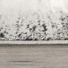Close-up of carpet edge on wooden floor