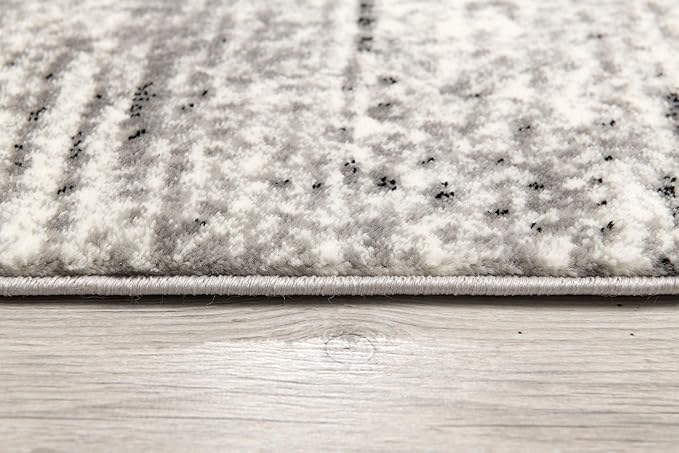 Close-up of textured gray and white carpet pattern.