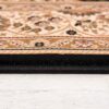 Detailed close-up of decorative rug edge on floor.