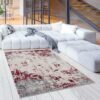 Modern living room with white sofa and abstract rug.