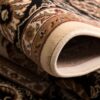 Close-up of rolled Persian rug design