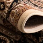 Close-up of rolled Persian rug design