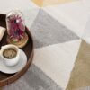 Coffee and book on geometric patterned rug