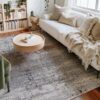 Cozy living room with beige sofa and round table.