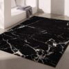 Black marble-patterned area rug in modern room.