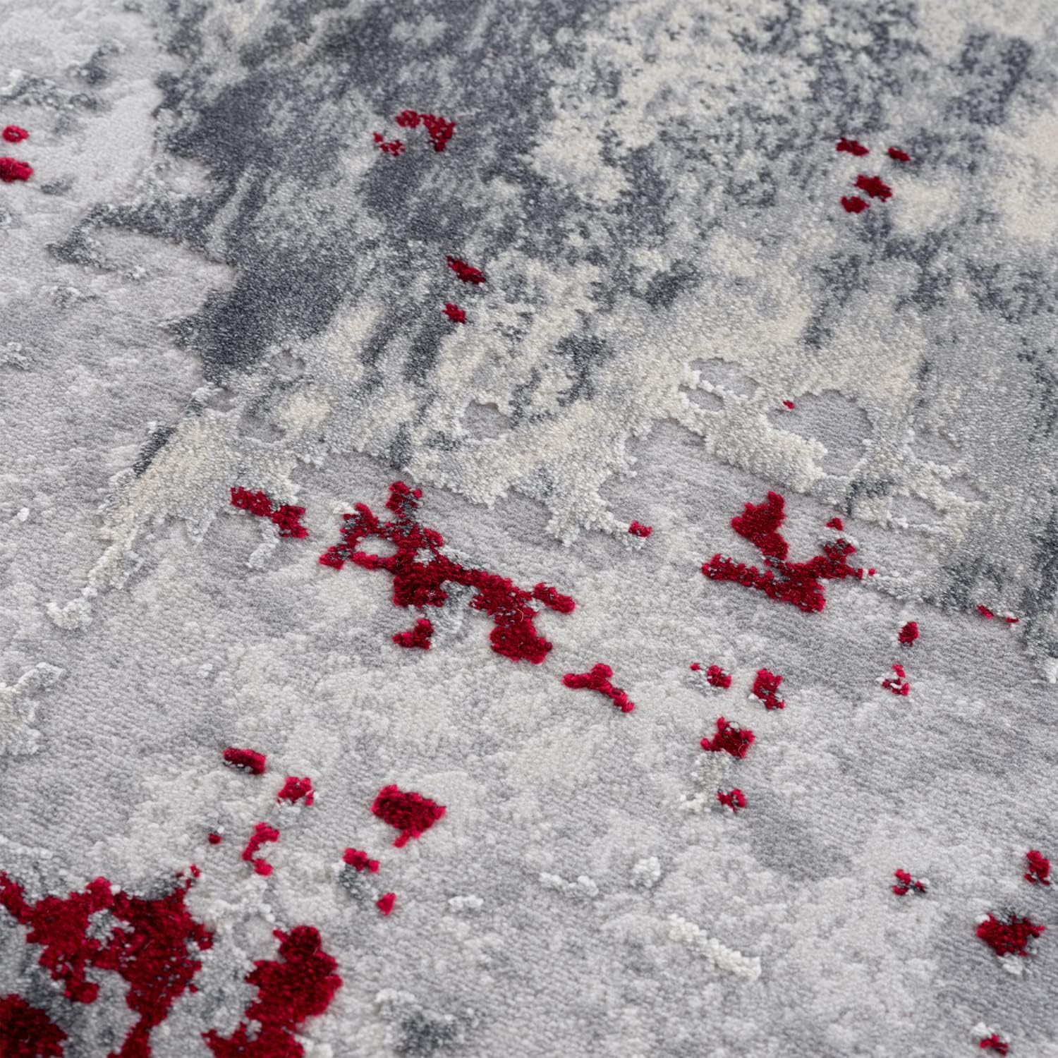 Abstract gray and red textured carpet design.