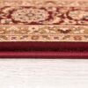 Close-up view of ornate red carpet edge.