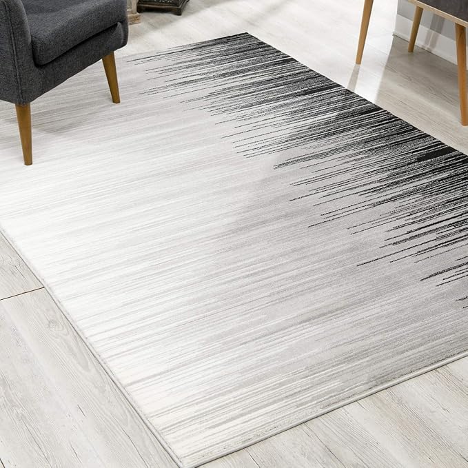 Modern ombre area rug on light wood floor.