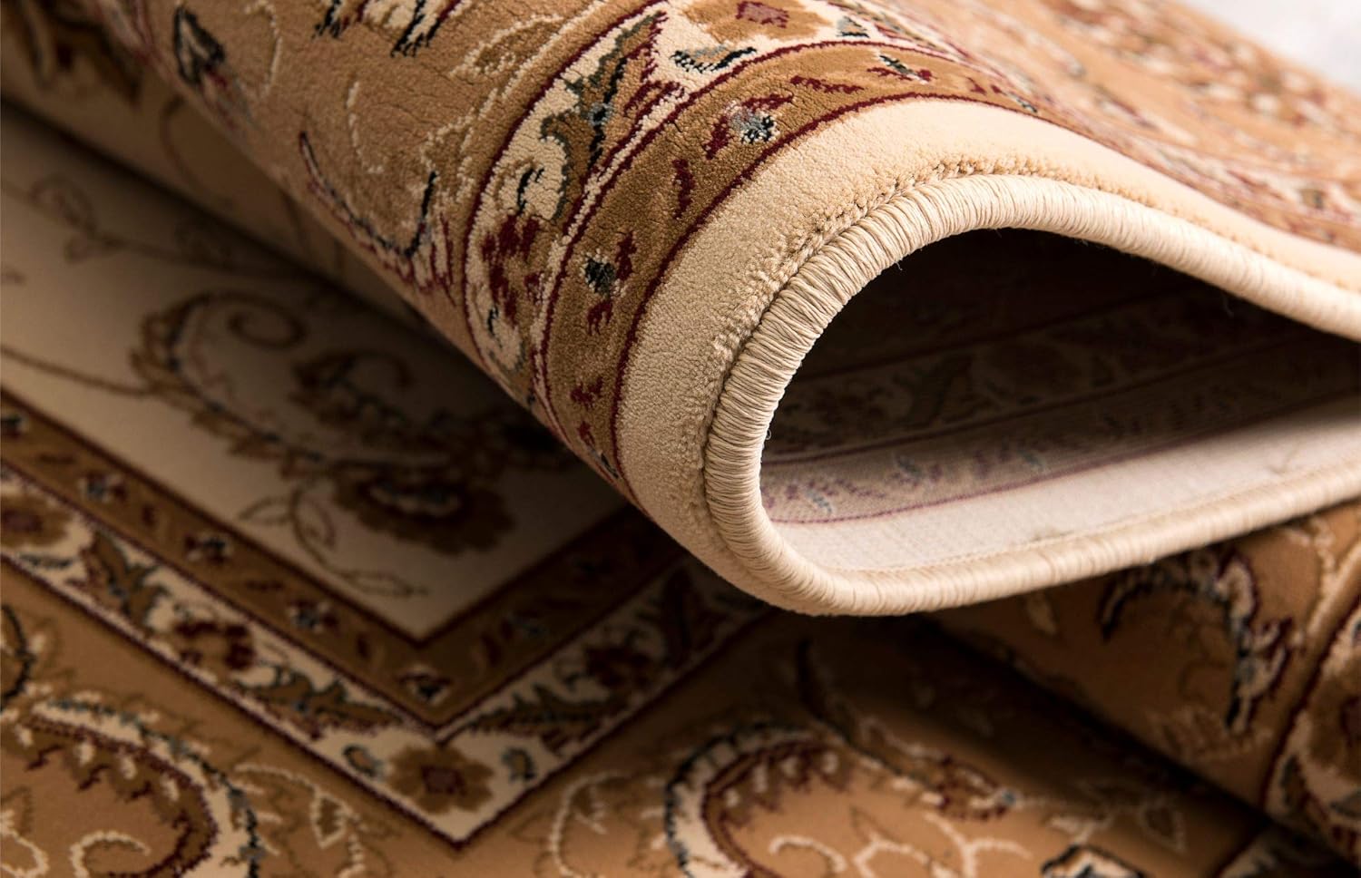 Close-up of rolled beige patterned rug