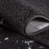Close-up of folded black textured carpet