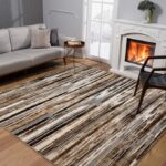 Cozy living room with striped rug and fireplace.