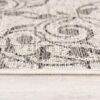Close-up of rug on wooden floor.
