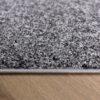 Gray carpet on wooden floor close-up