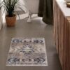 Bathroom with decorative geometric patterned rug