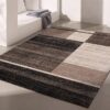 Modern geometric rug on minimalist floor setting.