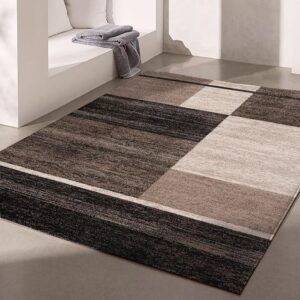 Modern geometric rug on minimalist floor setting.