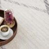 Coffee, open book, flowers on round tray.