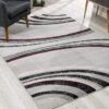 Modern area rug with gray and red geometric design.