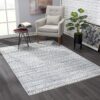 Modern living room with patterned rug and chair.