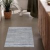 Bathroom with patterned rug and plant