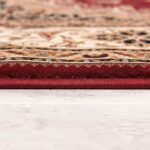 Close-up of ornate red and beige rug