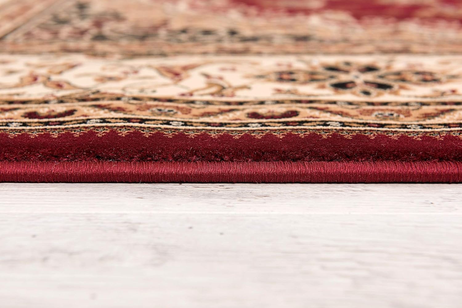 Close-up of ornate red and beige rug