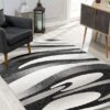 Modern living room with black and white abstract rug.