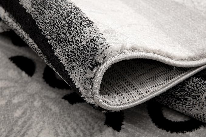 Close-up of rolled black and white textured rug.