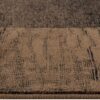 Close-up of textured brown carpet flooring.